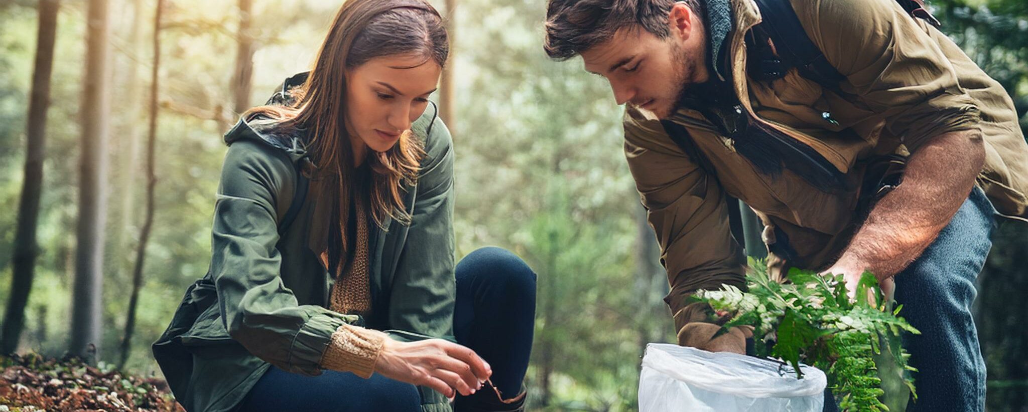 man and a woman lost in the forest searching for food to eat because they are lost