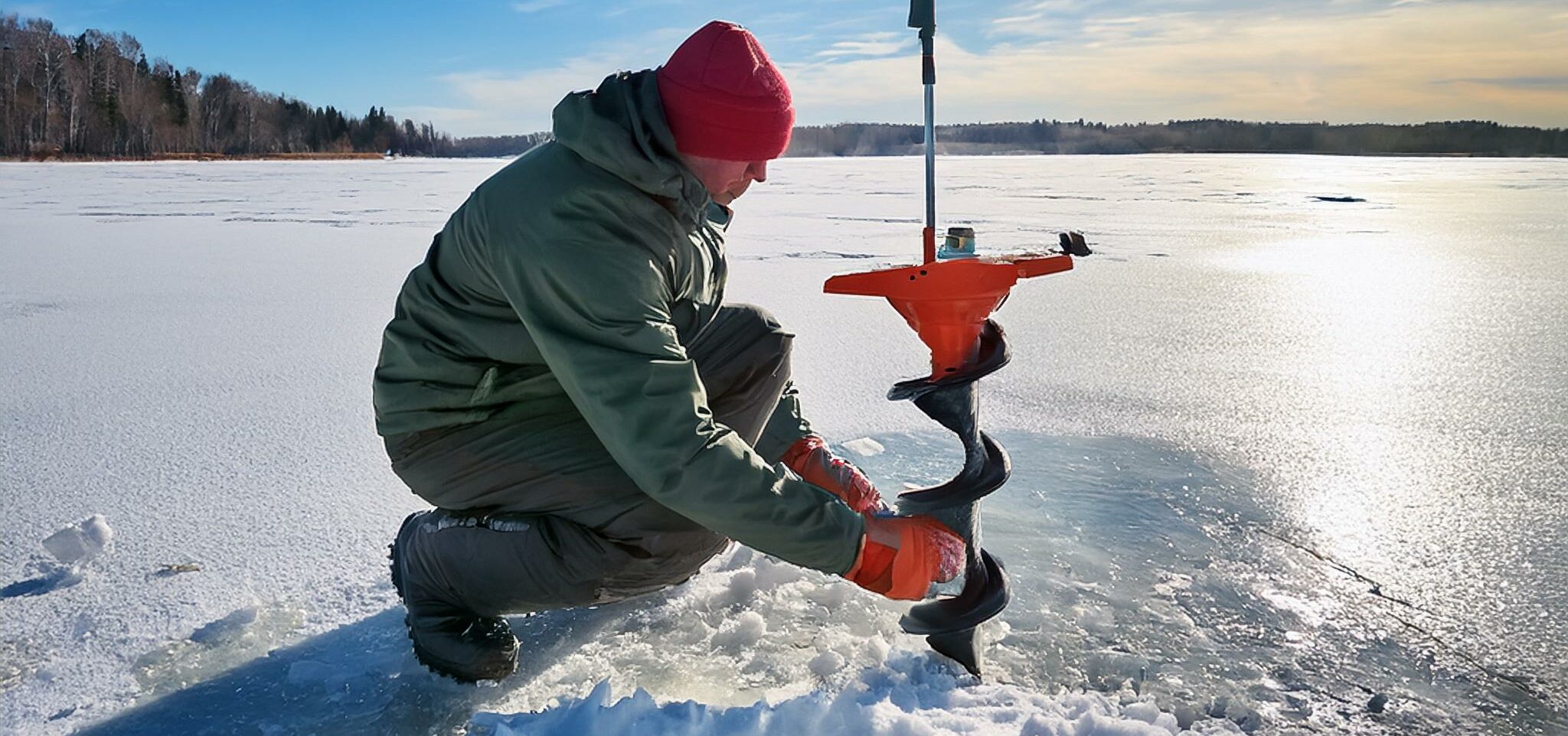 fisherman using an ice auger to test the thickness of the ice before ice fishing