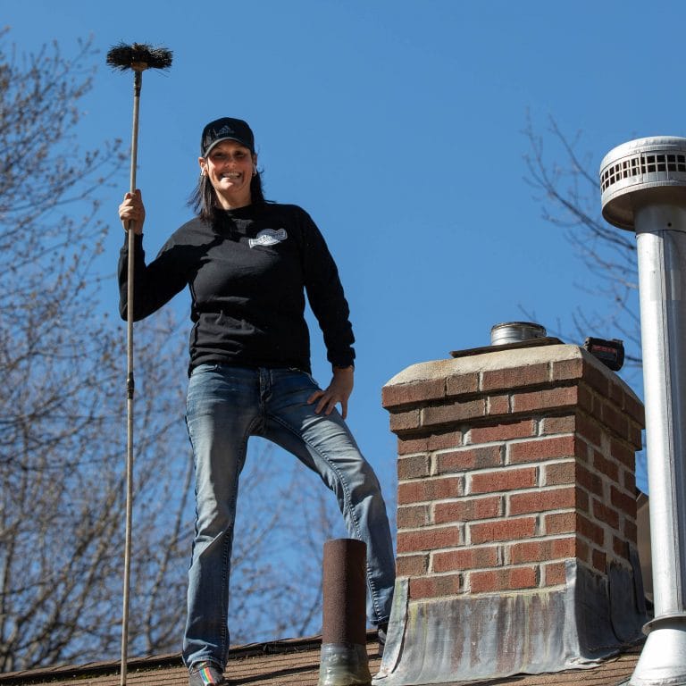 Woman Chimney Sweep Holding a wire brush